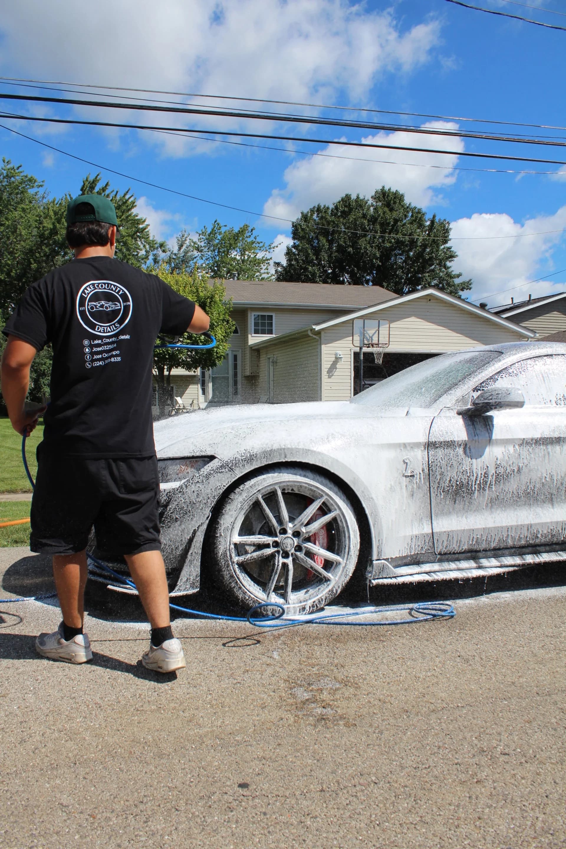 Jose foam-washing a customer's car